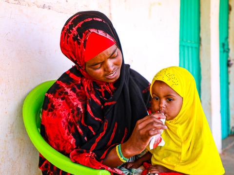 Umul and Sefa eating RUTF
