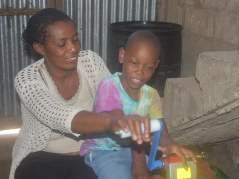 Mother and child using hand crank