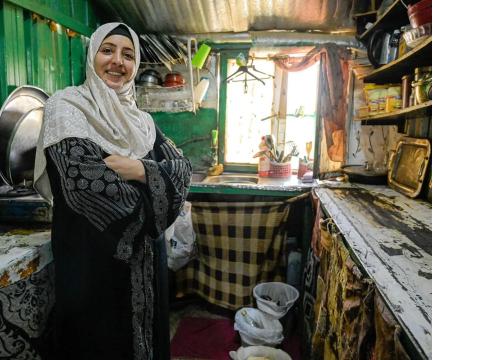 Woman standing in her house, smiling
