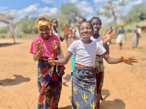 Girls walking in a group down a dirt path