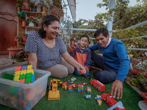 Parents playing with their child