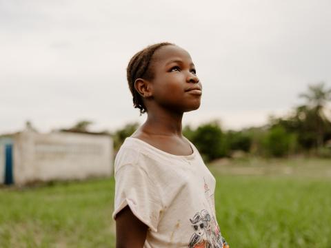 Fatima stands outside her home. A quiet moment of hope and God’s presence / Sierra Leone/2025.