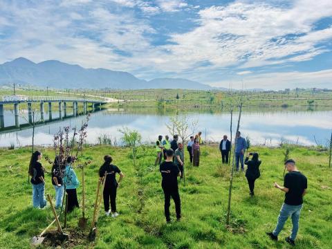 Youth cleaning near restored lake