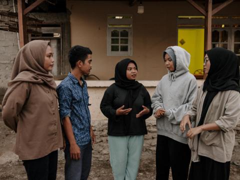 A group of youth talking together in their community