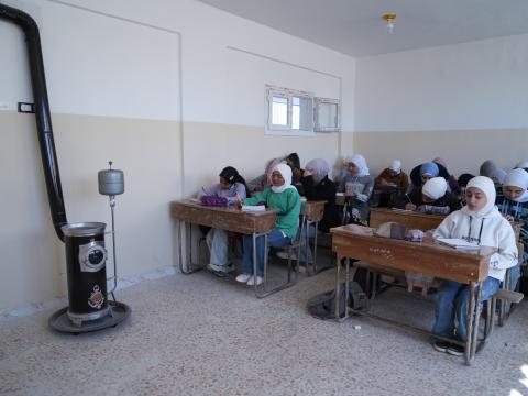 Photo of children in our supported classroom next the heater