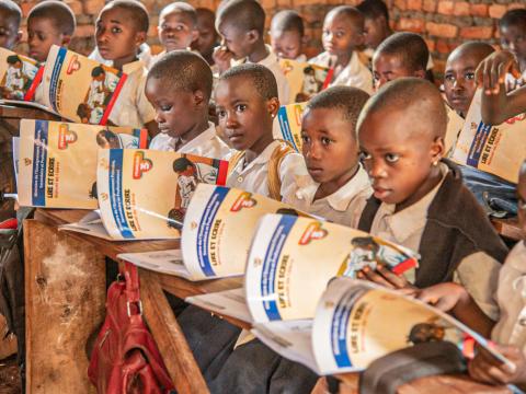 Pupils reading books distributed by World Vision