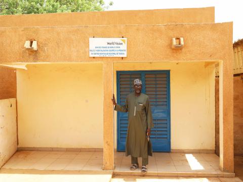 Photo of Dr. Sabo in front of the newly built hall