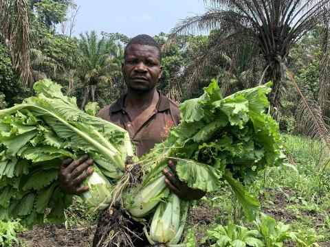 One of the beneficiaries holding his cabbage
