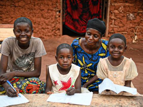 Rebecca assisting her children to do homework