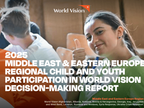 A young participant sits in a group setting and gives a thumbs-up gesture during a youth engagement activity. The image appears on the cover of the 2025 Middle East & Eastern Europe Regional Child and Youth Participation in World Vision Decision-Making Report.
