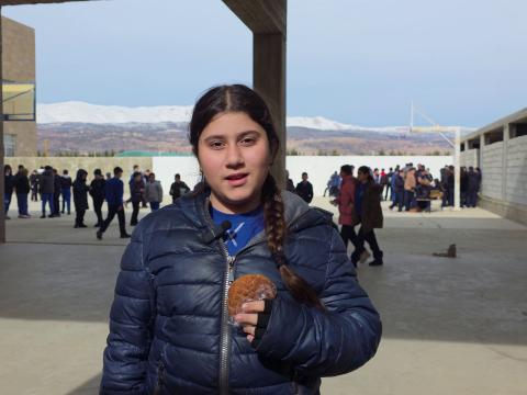 Benita, a Grade 6 student, holding a healthy snack during her school break.