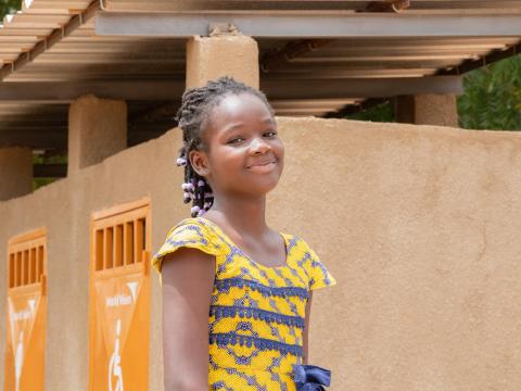 A little girl from Burkina Faso smiling at the camera