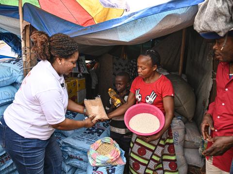 A World Vision staff distributing food to a family