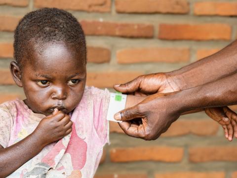 A health worker measuring Gakuru's hand