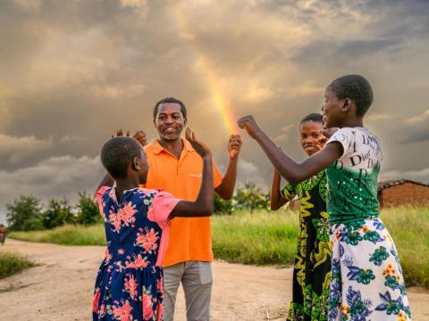 A World Vision staff interacting with children