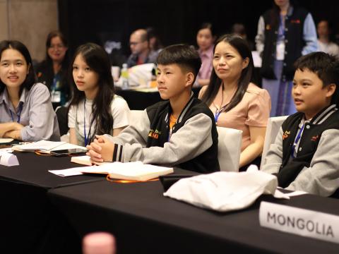 Children sit a table at a Young Minds Camp event