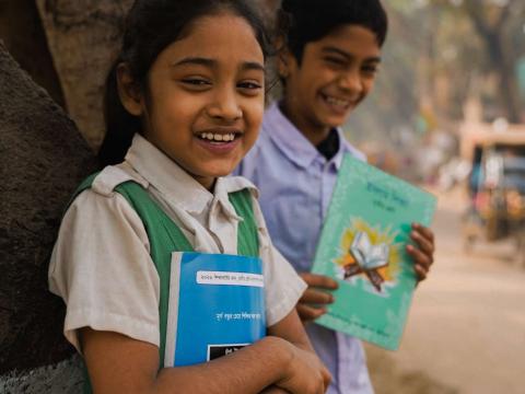 boy and girl holding a book