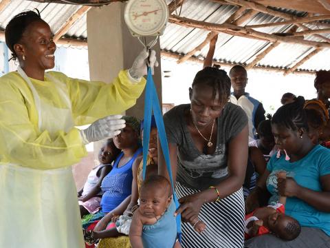 World Vision seeks to ensure that children like little Abdul enjoys quality health care Baby Abdul experiencing weight check