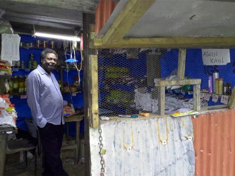 Savings success Charlie standing in his shop