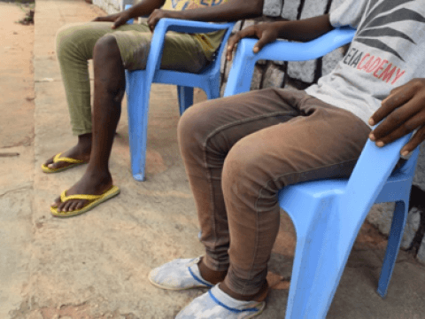 David and another demobilized child sit at the centre for former child soldiers in Kasai Central