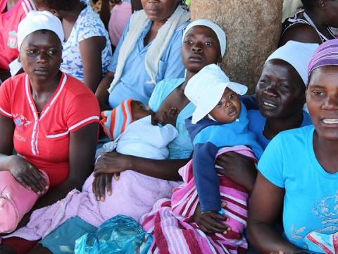 Mothers in Zimbabwe wait for the food packs distribution.