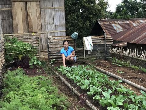Yohana Kurniati (25) plants vegetables in front of her house in order to make her baby healthier. Nutrition Garden