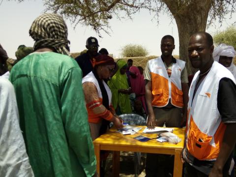 Emergency response team registering vulnerable people before distributing essential hygiene kits consisting of jerry cans, soaps and other non-food items