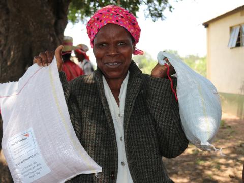 Vulnerable farmer with her sorghum and cow peas seeds from World Vision
