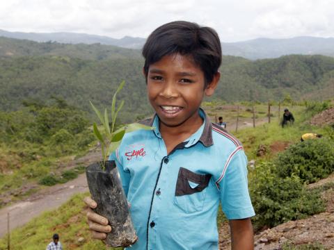 Recardo helped to plant trees near his school. Photo: Jaime dos Reis/World Vision