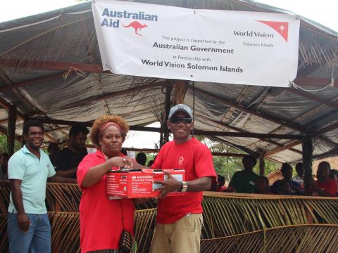 Rose Mary Hou received the cooking competition's winning prize from a representative of Origin Gas 