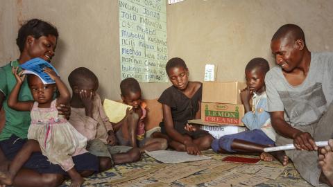 Mukonda with his family- he has four children whom he encourages to read through the reading corner and his has also taken up reading through this iniatitive.jpg