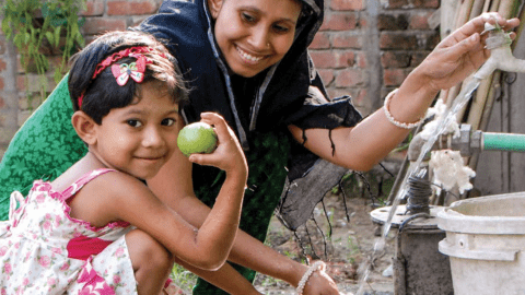 Mother with daughter using clean water