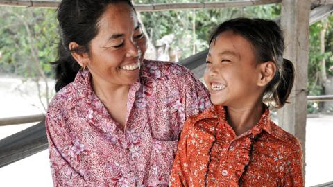 Khmer mother and daughter smile at each other