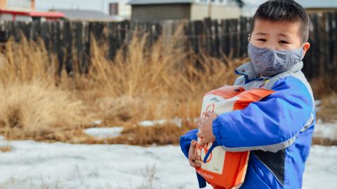 Child holding food during COVID19 relief