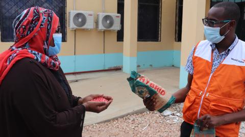 Mwanajuma Hiribae, the Tana River County Executive Committee Member (CEC) for Agriculture receives samples of the seeds from World Vision.©World Vision Photo