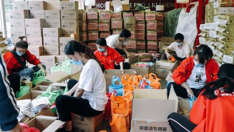 World Vision staff and partners packing relief packages for children and families during COVID-19