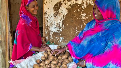 women buy and sell produce 