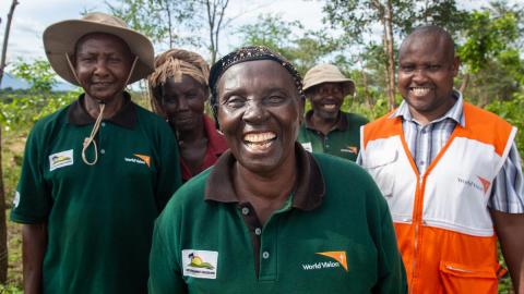 World Vision staff member with volunteers learn about alternative farming practices