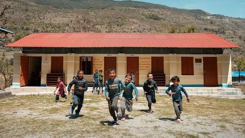 Children in front of earthquake resilient school building