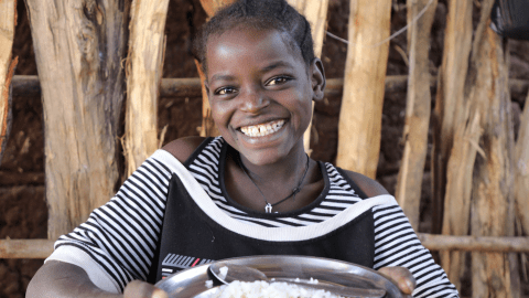 A child holding a meal at school