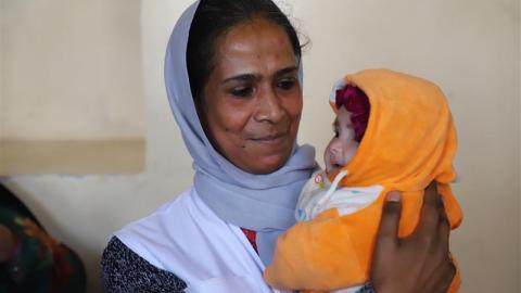 Asuntha holding a baby