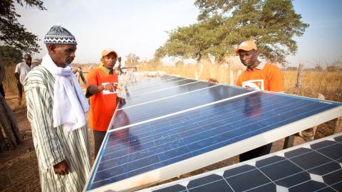 World Vision staff and a village chief inspect solar panels for a water pump in Senegal. World Vision staff and a village chief inspect solar panels for a water pump in Senegal.