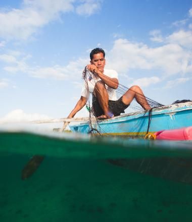 A fisherman in the Philippines uses a microloan to fund his small business