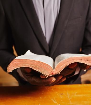 A Pastor in Ghana holds his Bible