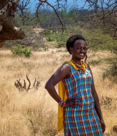 Nancy, a formally sponsored child, stands at her home in Kenya