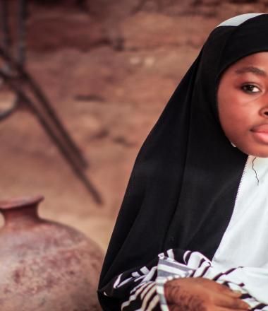A Nigerian girl with a black headwrap
