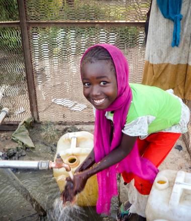 A Sudanese girl at a water well