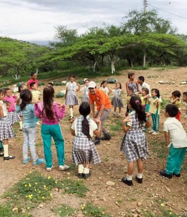 Venezuela Migrant Crisis Response Staff with children playing in a circle
