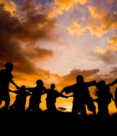 Silhouetted children at sunset