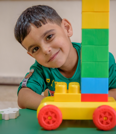 Boy playing with blocks and car